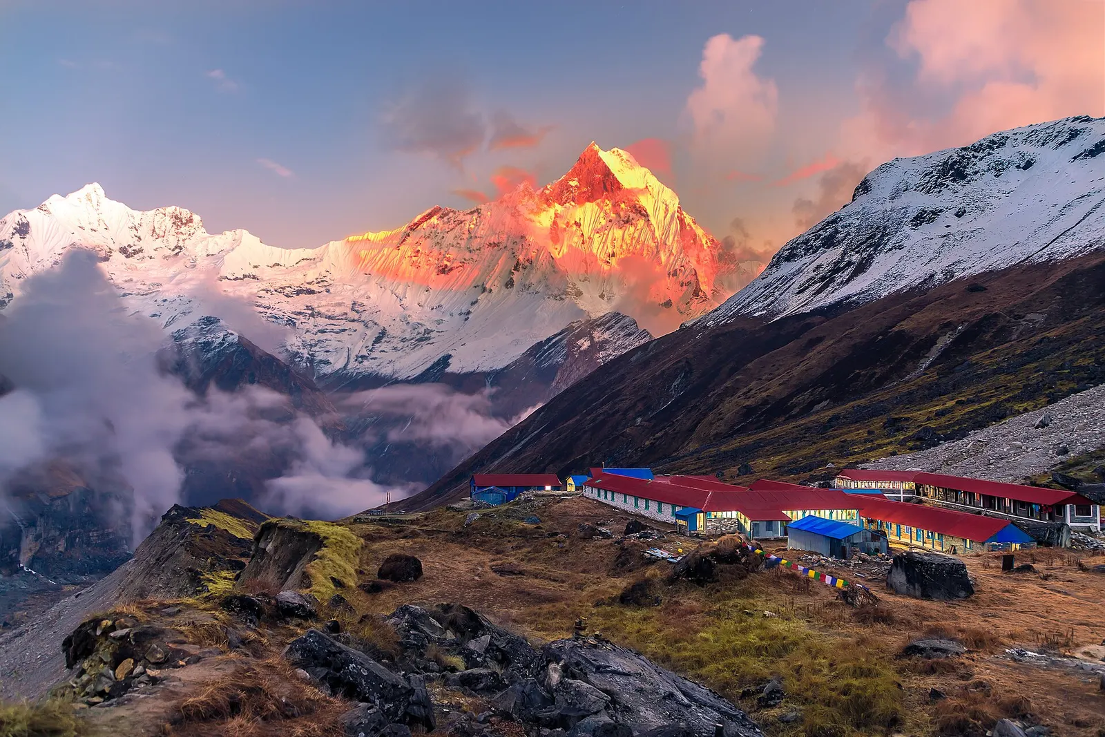 Evening light on the peaks above Annapurna Base Camp, with the lodges of the camp on the moraine below.