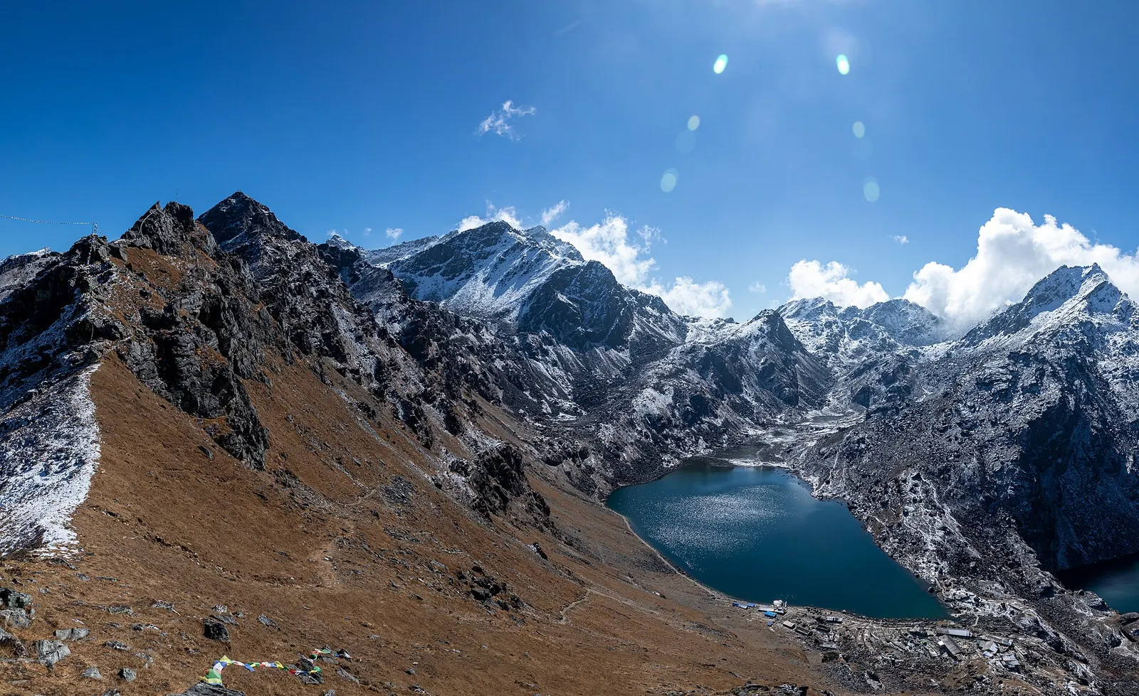 The blue Gosaikunda lake in a rocky alpine basin.