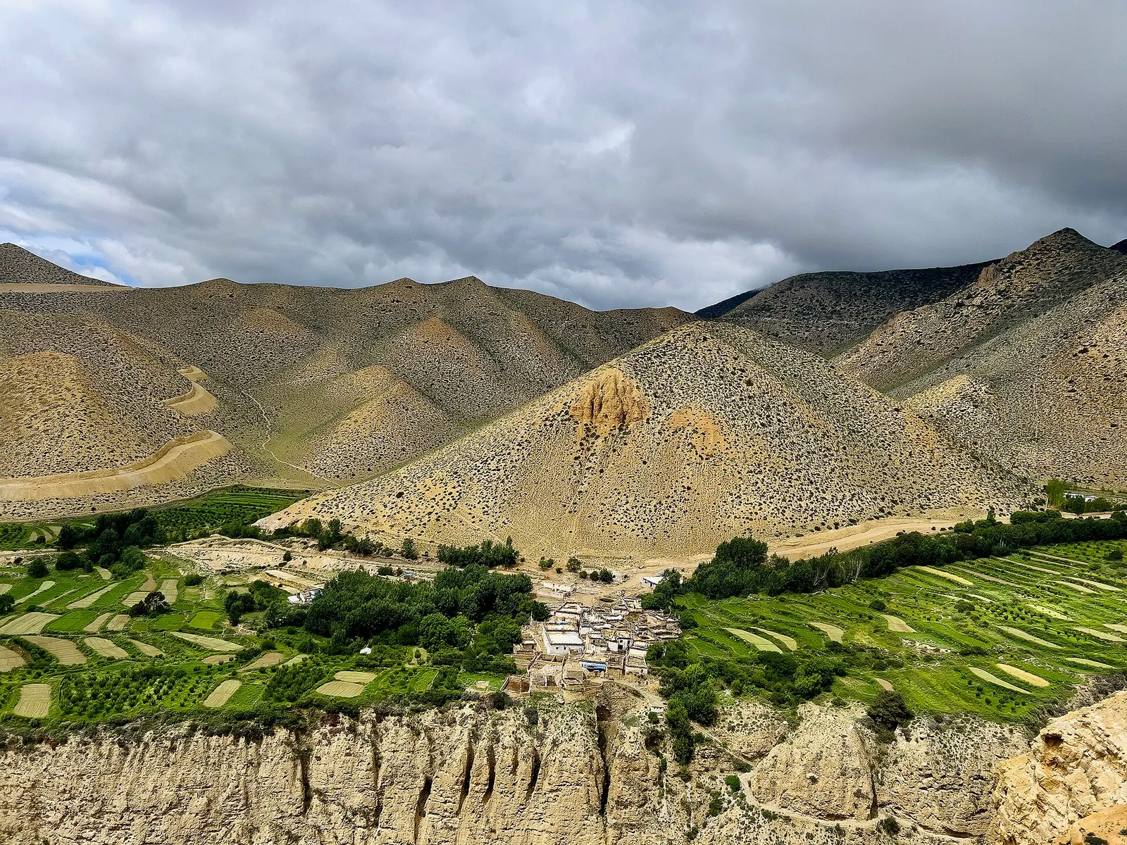 Ghyakar village and its fields set among bare highland hills in Upper Mustang.